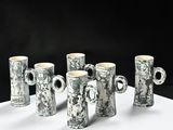 five mugs that are sitting on a table