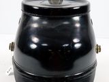 a black container with a coin in it on a white surface