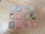 several different types of stamps on a wooden table