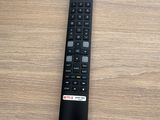 a remote control sitting on a wooden table