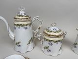 three pieces of porcelain tea and coffee set on a table