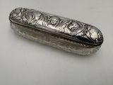 silver plated box with flowers and leaves on it on a white surface