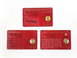 three red cards with gold coins on them sitting next to each other