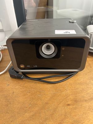 a small projector sitting on a table next to a phone