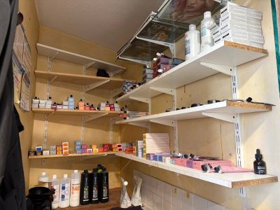 a shelf with many bottles and containers on it in a room