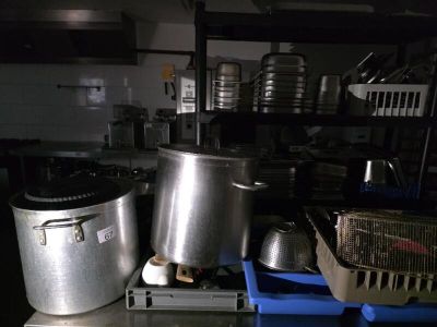 several pots and pans are sitting on a table in a kitchen