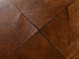 a close up of a wooden floor with a square pattern