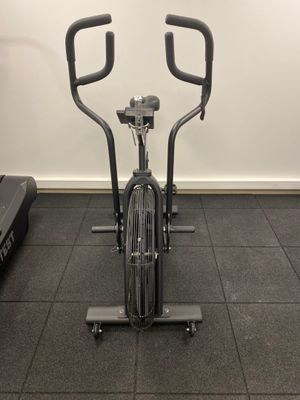 an exercise bike in a gym with treads and a tread machine