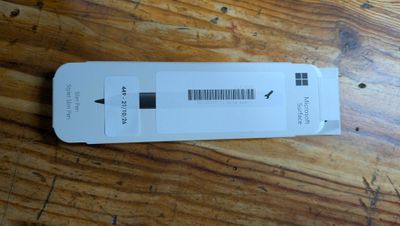 a white box with a barcode on it sitting on a wooden table