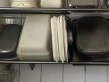 many dishes and pans on the shelves in the kitchen