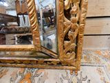 a mirror that is sitting on the floor next to a rug