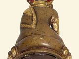a small bell with a crown on top of it