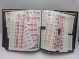 an open book with stamps on it sitting on a table