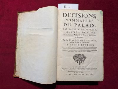 un livre ouvert posé sur une table recouverte d'un tissu rouge