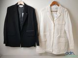 two jackets hanging on the wall next to each other