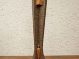 a wooden sculpture of a person standing on a shelf
