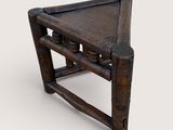 a close up of a wooden stool with a seat made out of wood