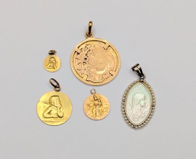 a group of gold and silver coins and pendants on a white surface