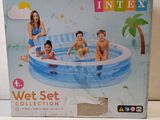 an inflatable swimming pool with three children sitting on it