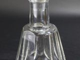 a clear glass bottle with a clear top on a black surface