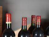 several bottles of wine are lined up in a row on a table