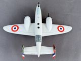 a small model of a fighter jet on a gray surface