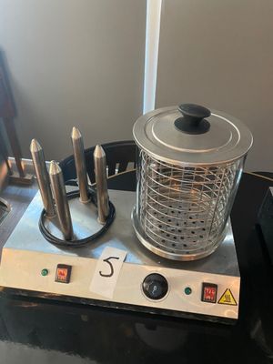 a blender with knives on a table next to a chair