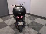 a motorcycle that is parked in a room with a checkered floor