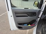 a white truck with a door open in a parking lot