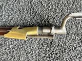 a close up of a metal pipe with a wooden handle on a carpet