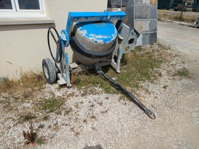 a cement mixer sitting on the side of a building