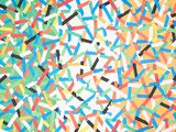 colorful confetti sprinkles are scattered on a white surface
