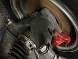 a close up view of a car ' s front wheel and suspension