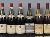 several bottles of wine are lined up on a table