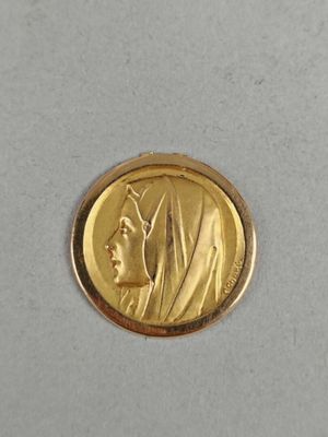 a close up of a gold coin with a woman ' s face on it