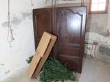 an image of a room with a door and a pile of christmas trees