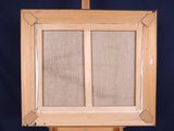 painting on easel with canvas and wooden frame against a blue background