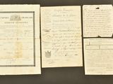 several old papers are on display on a black surface