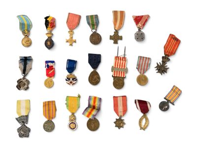 many medals and medals on display on a white surface