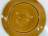 a yellow plate sitting on top of a white table