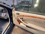 a car door with the door open and a bike in the background