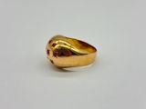 a close up of a gold ring on a white surface