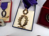 three medals and a purple ribbon on a table
