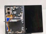 someone is removing the back panel of a laptop with a pair of scissors