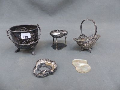 several silver objects are displayed on a table with a price tag