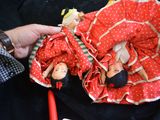 a person that is holding a doll in a bag