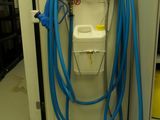 a blue hose attached to a white toilet in a room