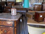 une table sur laquelle est posée une lampe, dans une pièce remplie de meubles