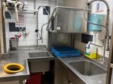 a kitchen with a sink and a stove in it