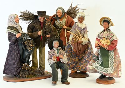 five figurines of people dressed in traditional clothing